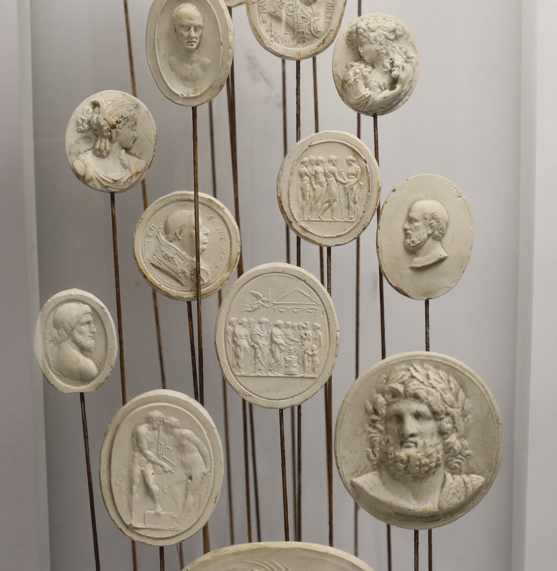 Twenty two Grand Tour intaglio reliefs, under glass dome, height 63cm.